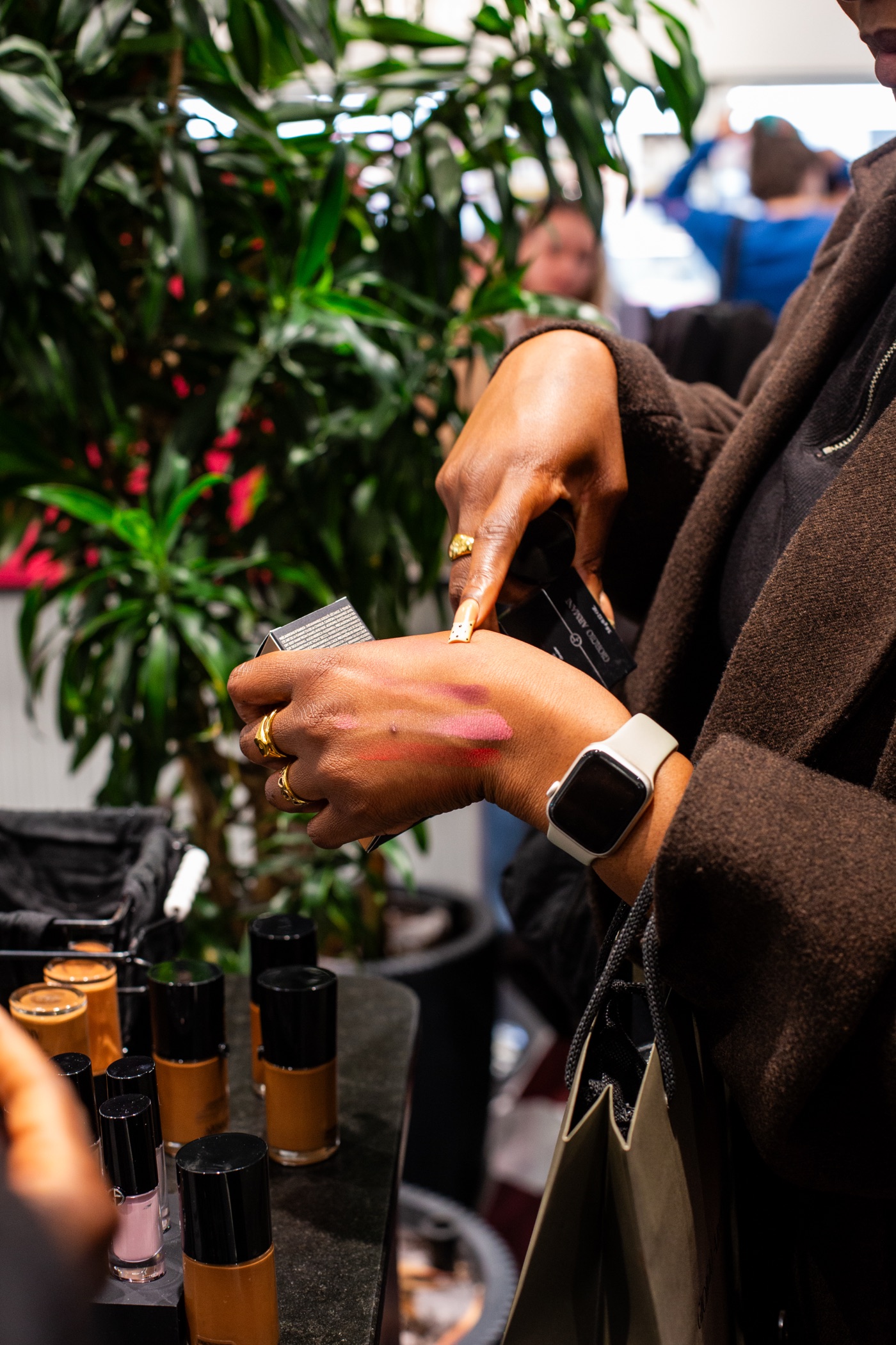 A guest swatching Armani Beauty shades on the back of her hand at the Armani Beauty Luminous Silk Foundation masterclass
