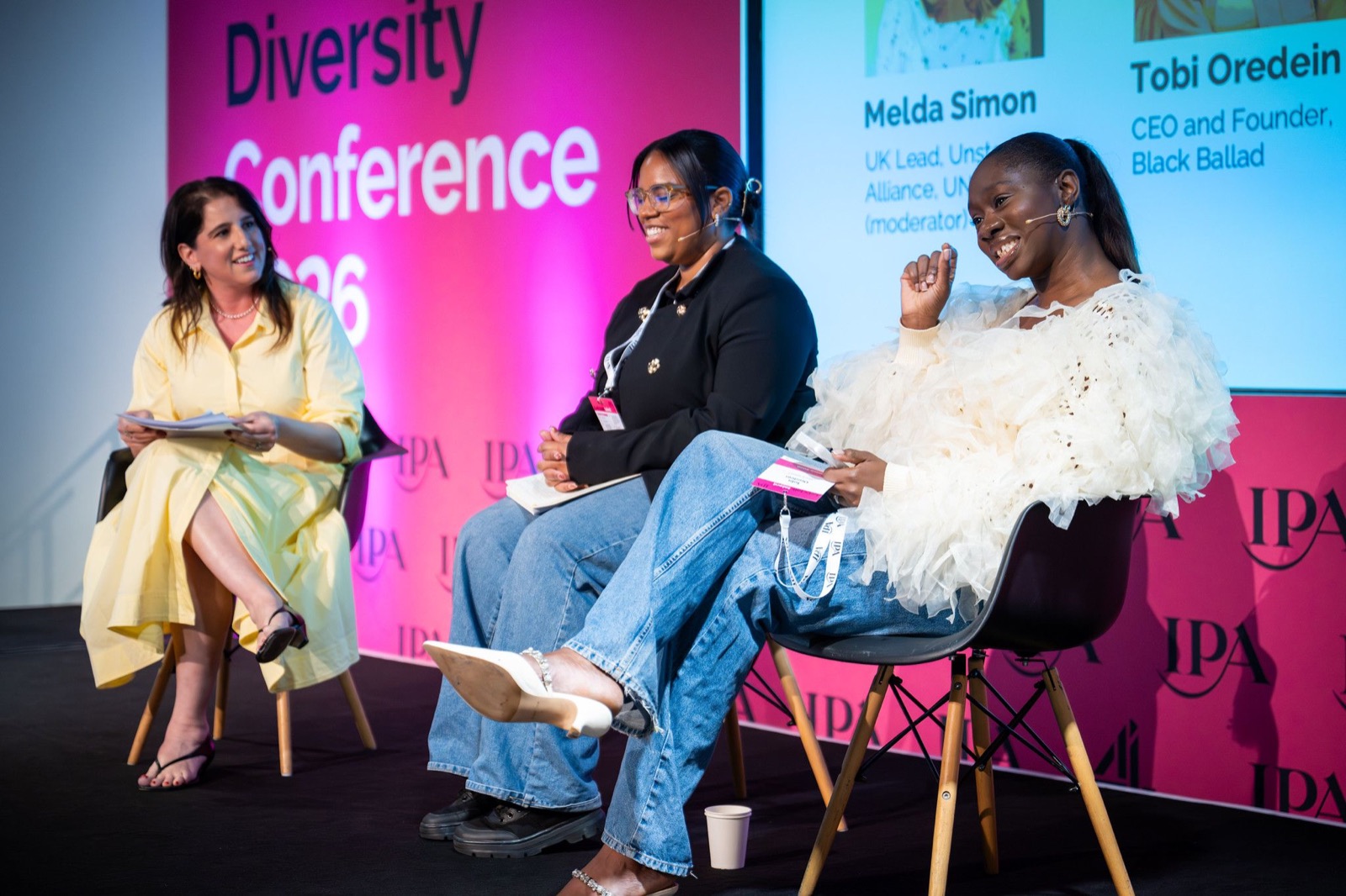 Tobi Oredein laughing on a panel at the IPA Talent and Diversity Conference 2026, her name on the screen behind