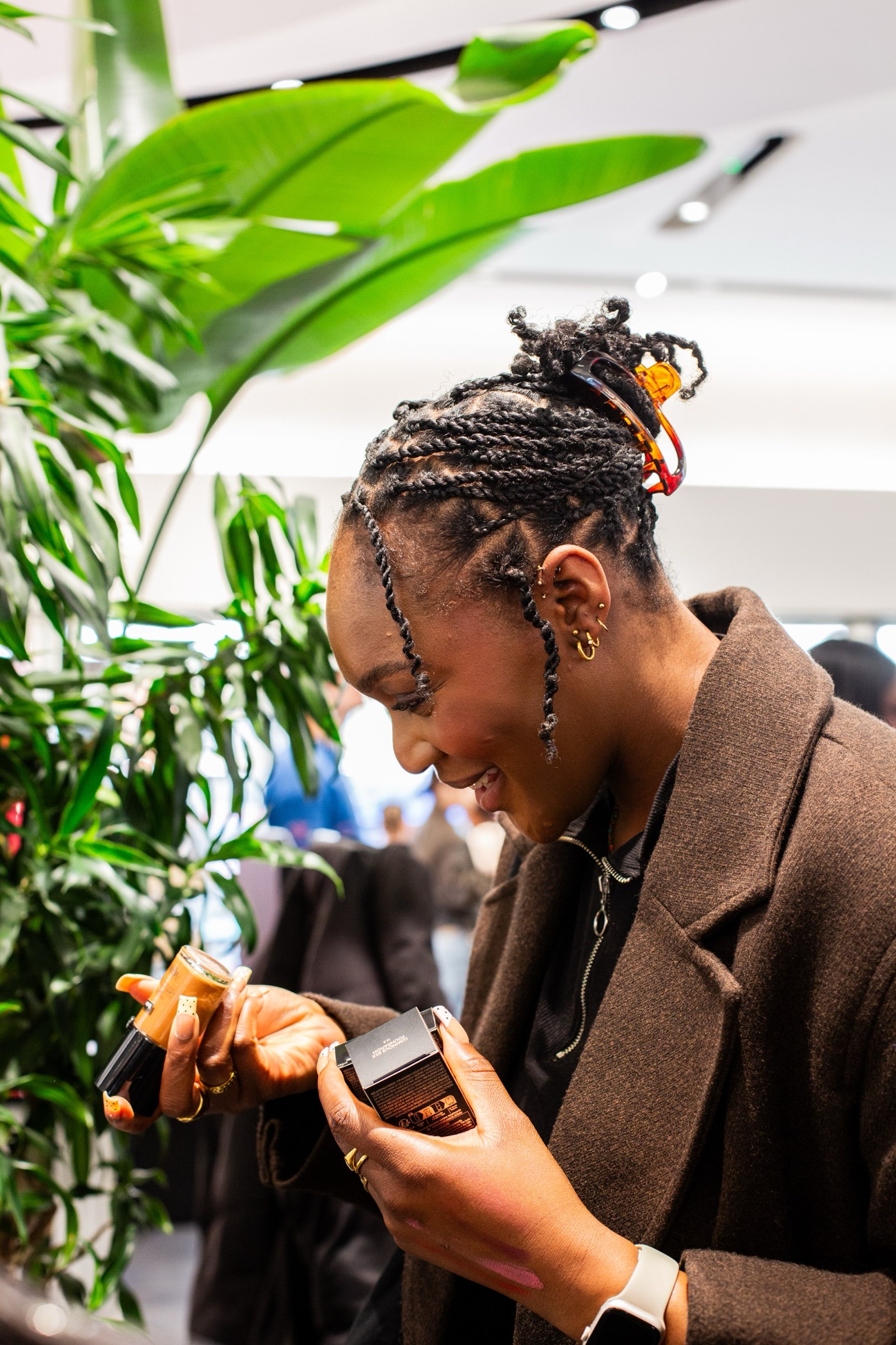 A guest laughing as she tries a shade at the Armani Beauty stand, Black Ballad Weekender 2026