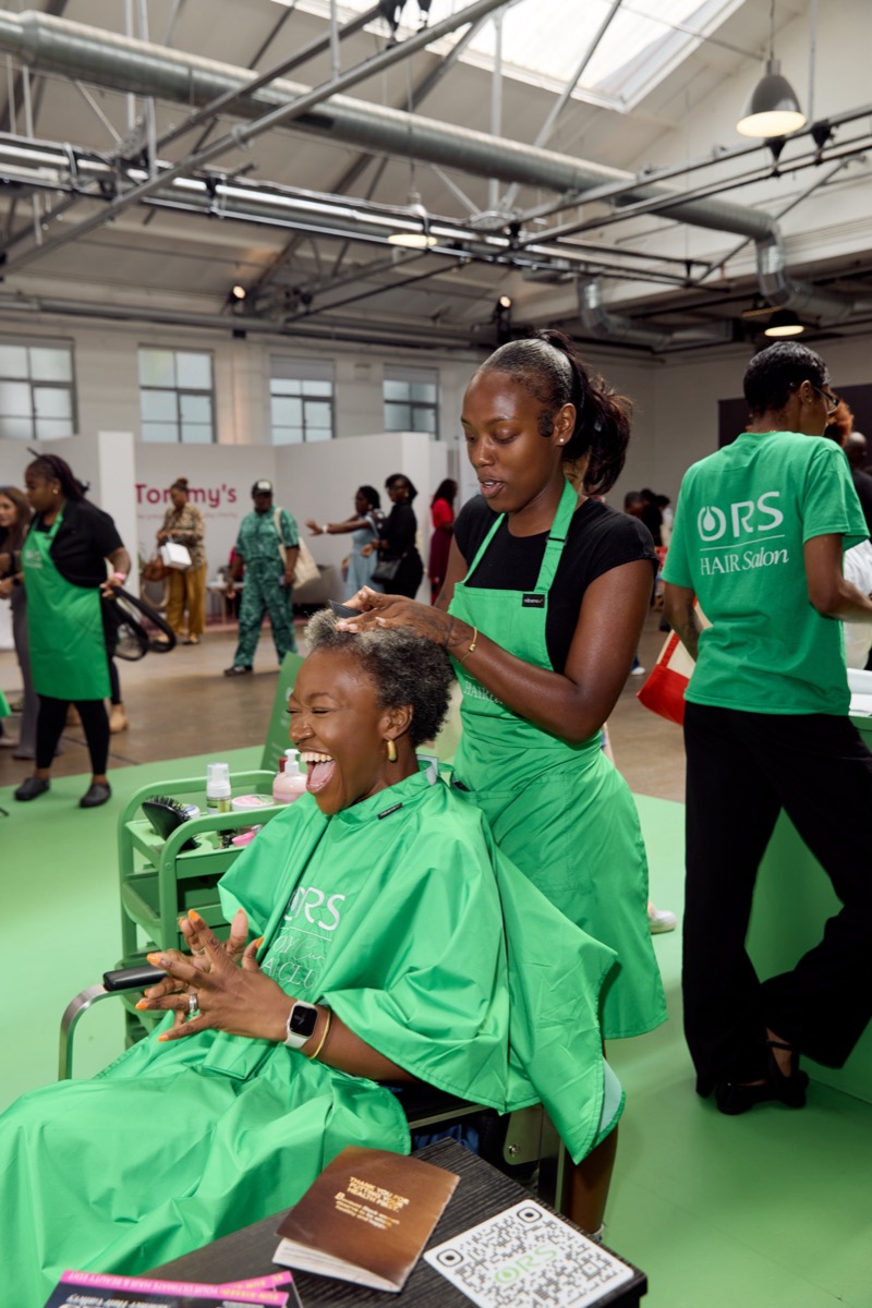 A guest having her hair done at the ORS salon activation