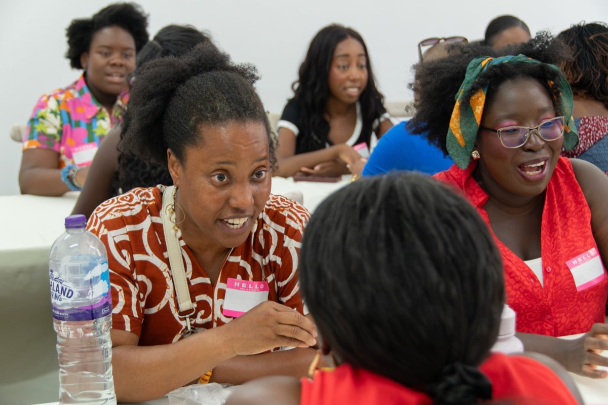 Guests talking around a workshop table